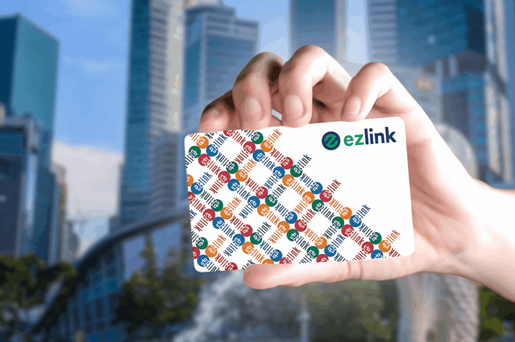 Hand holding an EZ-Link card in front of Singapore’s modern skyline, symbolizing easy access to Singapore’s MRT system for expats and tourists. The EZ-Link card is a physical card used for MRT rides, bus rides, and train services across MRT lines including the North South Line, East West Line, Circle Line, Downtown Line, North East Line, Thomson East Coast Line, and LRT lines like Bukit Panjang LRT. This Singapore MRT Guide for Expats highlights how to pay directly using contactless bank cards, mobile wallets like Apple Pay, Samsung Pay, Fitbit Pay, or travel cards from other countries. Riders can simply tap at MRT stations, public buses, and ticketing machines to purchase single trip tickets or the Singapore Tourist Pass. The card works with the SimplyGo app, MyTransport app, Google Maps, and the official app to explore Singapore’s mass rapid transit system. Key interchange stations like Dhoby Ghaut, City Hall, Chinatown MRT, Marina Bay, Botanic Gardens, Orchard Road, Raffles Place, and Tanjong Pagar are accessible during peak hours, off peak hours, rush hours, and midnight daily. The image reflects Singapore’s cost-effective public transport, train frequency, operating hours, priority seats, admin fee details, and total distance coverage—ideal for planning journeys and rides with convenience stores nearby.