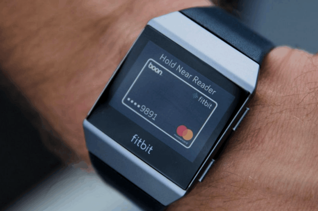 Close-up of a smartwatch displaying a digital payment interface with Fitbit Pay, ready for contactless payment at a Singapore MRT station—ideal for expats using mobile wallets like Apple Pay, Samsung Pay, and Fitbit Pay to pay directly for MRT rides, bus rides, and train services across Singapore’s mass rapid transit system. This Singapore MRT Guide for Expats highlights how to simply tap at MRT stations, public buses, and ticketing machines using contactless bank cards, physical cards like EZ-Link and NETS FlashPay, or travel cards from other countries. The image reflects easy access to MRT lines including the North South Line, East West Line, Circle Line, Downtown Line, North East Line, Thomson East Coast Line, and LRT lines like Bukit Panjang LRT. Expats can explore Singapore with the Singapore Tourist Pass, single trip tickets, and official apps like SimplyGo and MyTransport, supported by Google Maps and convenience stores. Key train stations and interchange stations such as Dhoby Ghaut, City Hall, Chinatown MRT, Marina Bay, Orchard Road, Raffles Place, Botanic Gardens, and Tanjong Pagar are accessible during peak hours, off peak hours, rush hours, off peak times, and midnight daily. The MRT map supports public transport planning with train frequency, operating hours, priority seats, admin fee info, first bus timings, total distance, and cost-effective journey options for every ride.