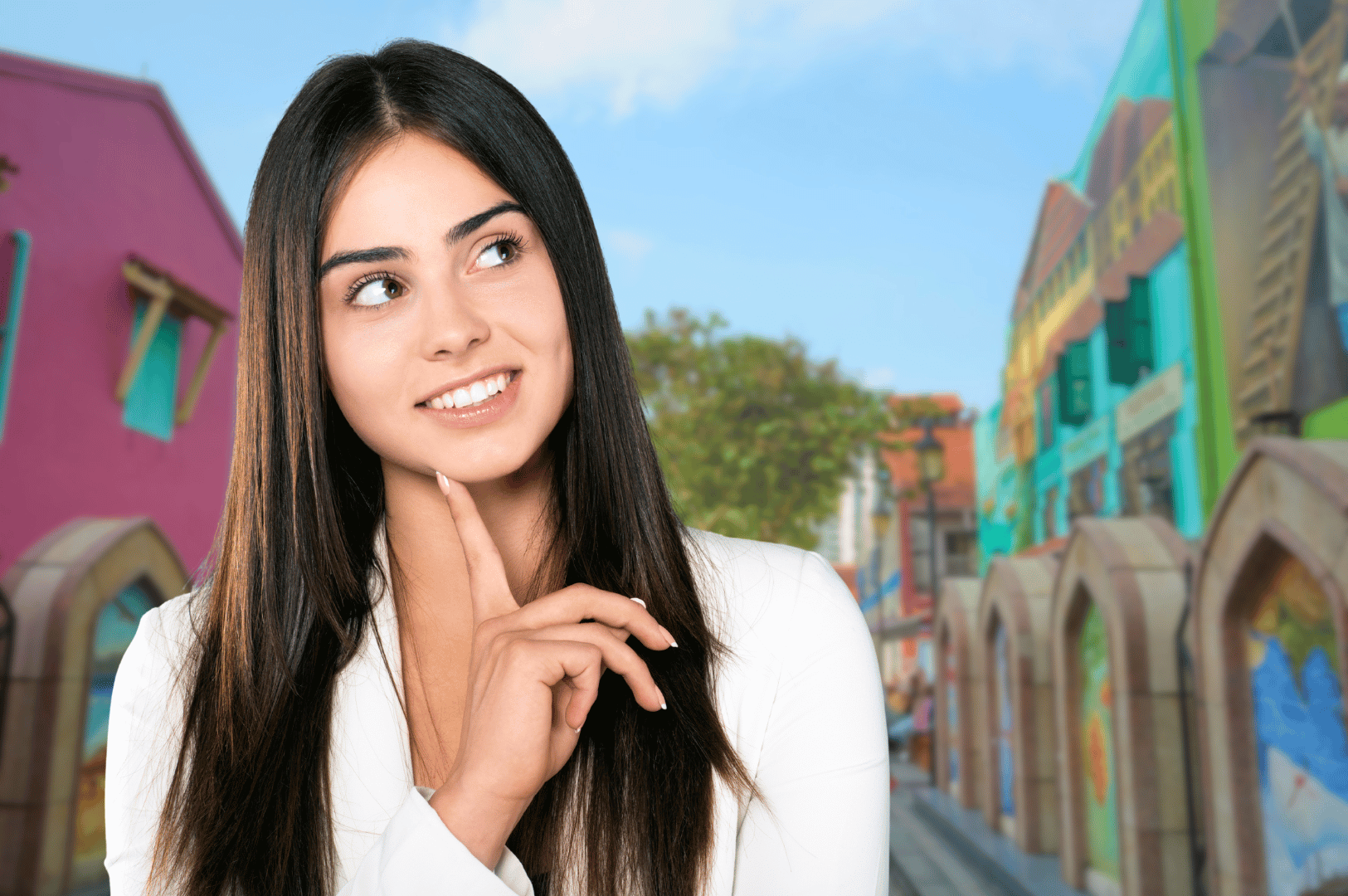 Young woman in white top standing thoughtfully in front of a row of brightly painted shophouses, with pink, turquoise, and yellow facades; a vivid, artistic streetscape that hints at Singapore’s rich cultural layers—perfect for introducing expats to the expressive quirks and colorful charm of Singlish in everyday life.