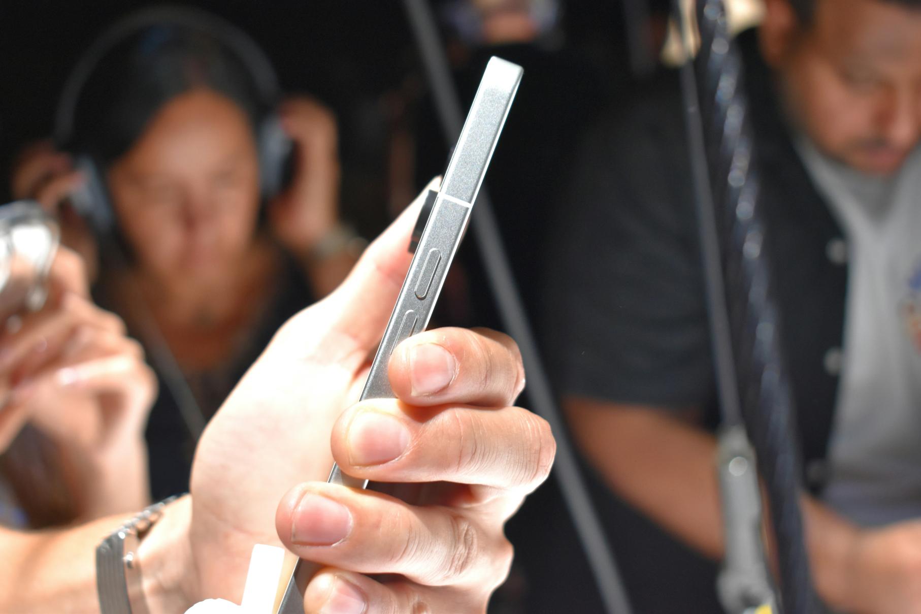 A close-up photo of a person on their phone while inside a public transportation.