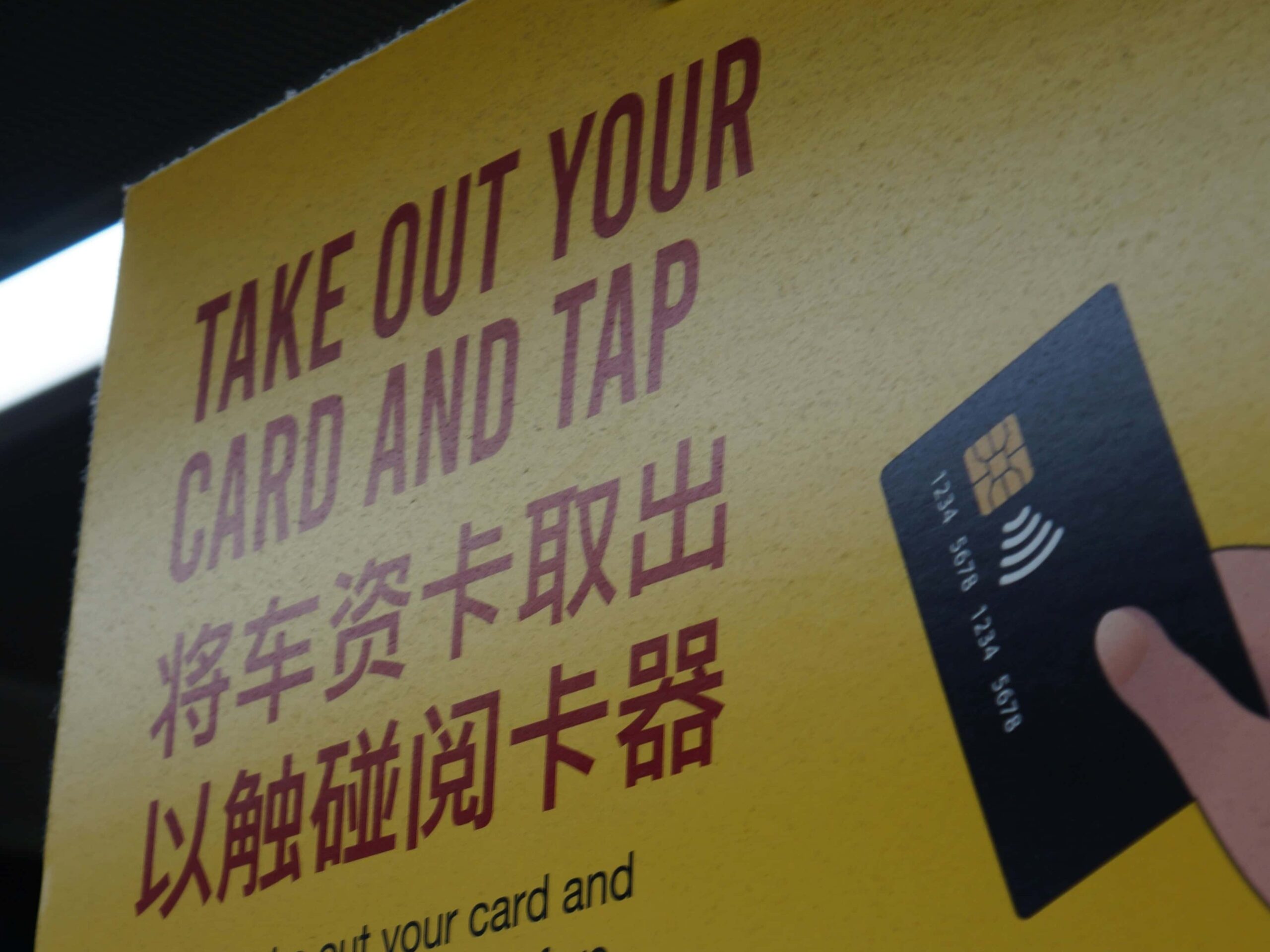 A signage in Orchard about their tap card system used for transits. 