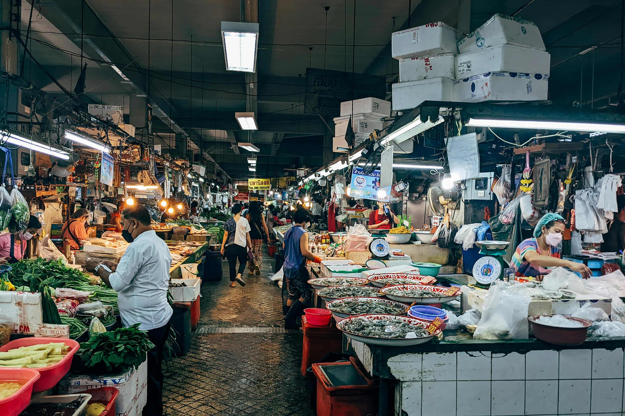 A busy wet market filled with the freshest seafoods and vegetables across from eachother.