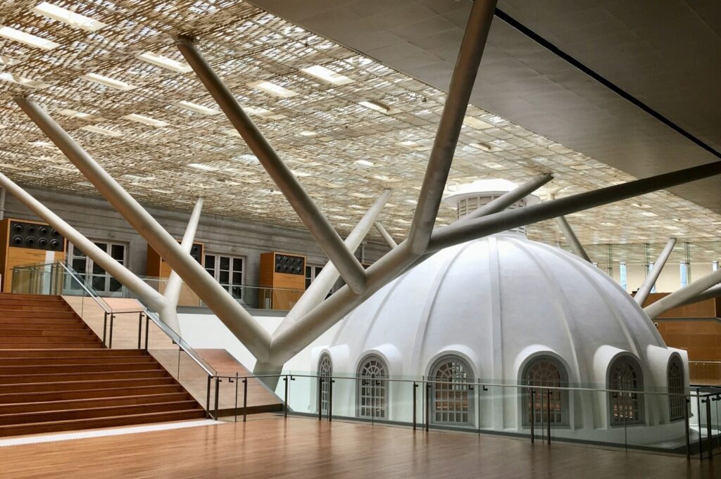 The National Gallery Singapore's interior showcases a stunning dome and a prominent staircase.