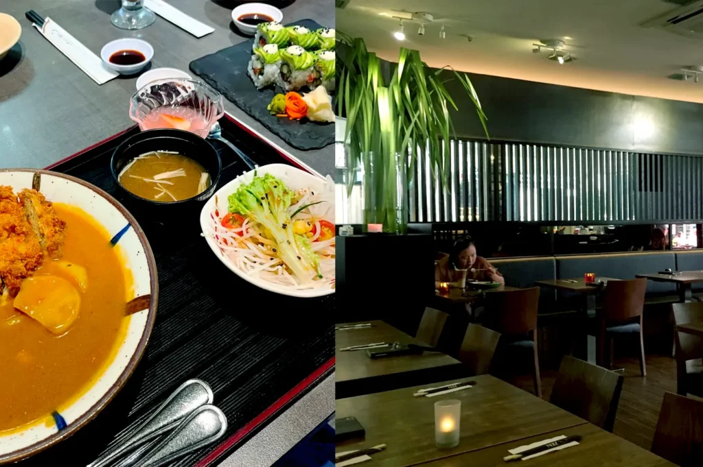 Japanese set meal with curry and sushi beside a dimly lit dining space.