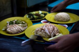 An image of a Hainanese Chicken Rice sitting on a tray ready to be served.