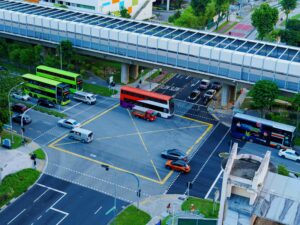 An aerial shot of an intersection with Singapore's bus transits.