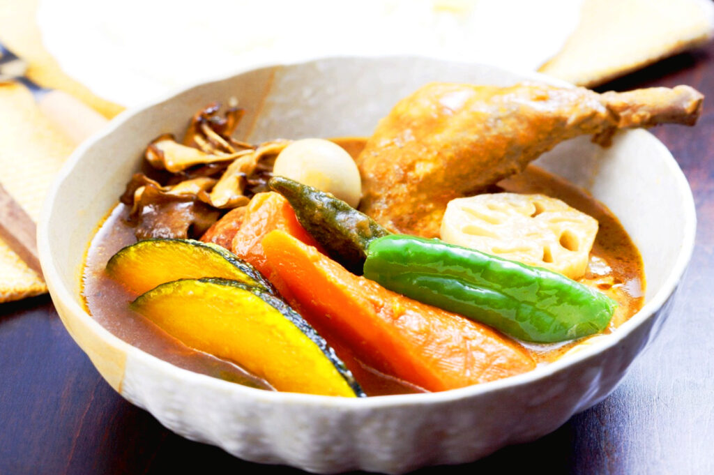 Authentic Hokkaido soup curry with chicken, pumpkin, lotus root, and seasonal vegetables