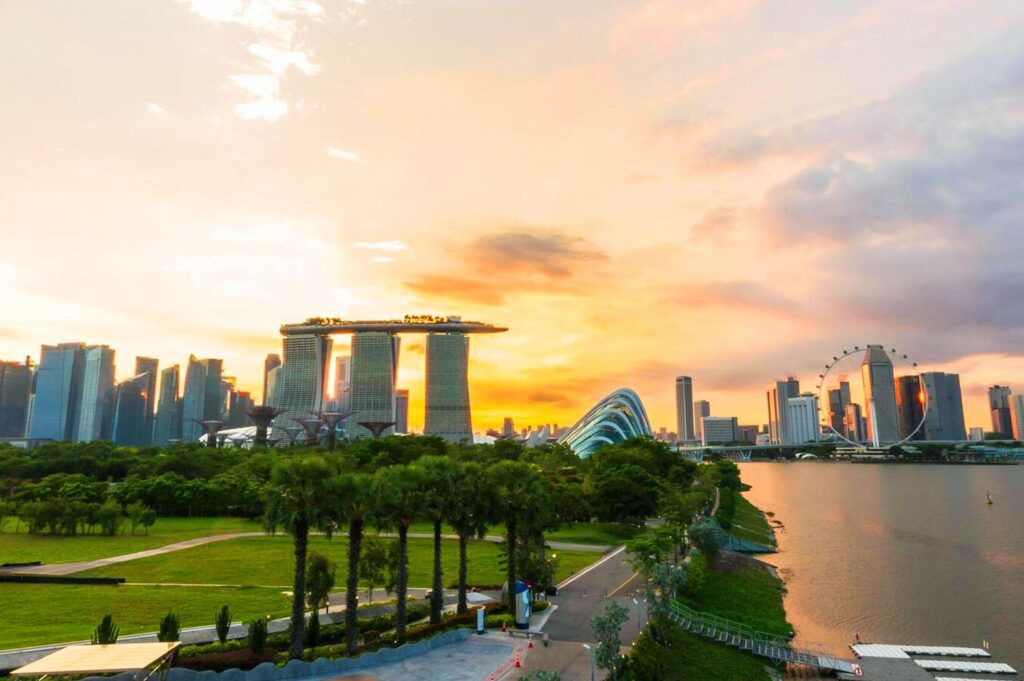 Singapore skyline at sunset with Marina Bay Sands and waterfront view.