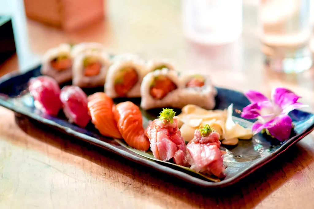 Sushi and maki platter with salmon, tuna, and artistic presentation