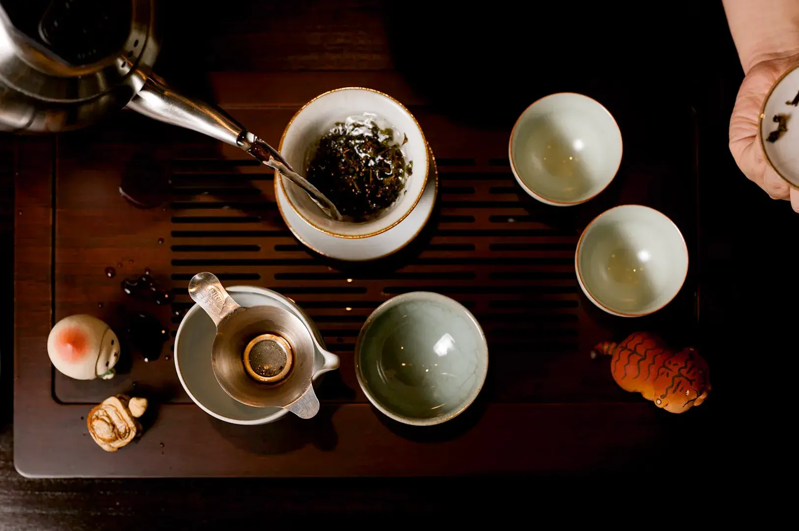 Traditional Chinese tea brewing set with loose leaf tea and teapot
