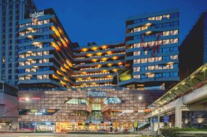 Funan Mall exterior with lyf Funan Singapore hotel building above.