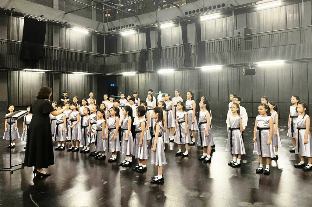 Singapore school choir rehearsal with students performing arts CCA activity, highlighting holistic education and student development