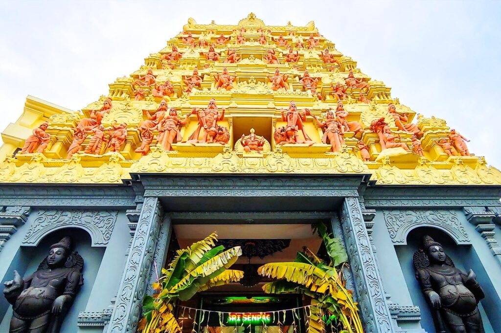 Sri Senpaga Vinayagar Temple ornate yellow gopuram entrance with intricate carvings in Katong cultural district