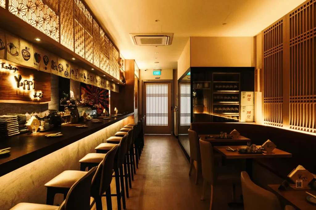 Izakaya Yoppi warm wooden interior with bar seating and modern Japanese dining ambiance in Tanjong Pagar