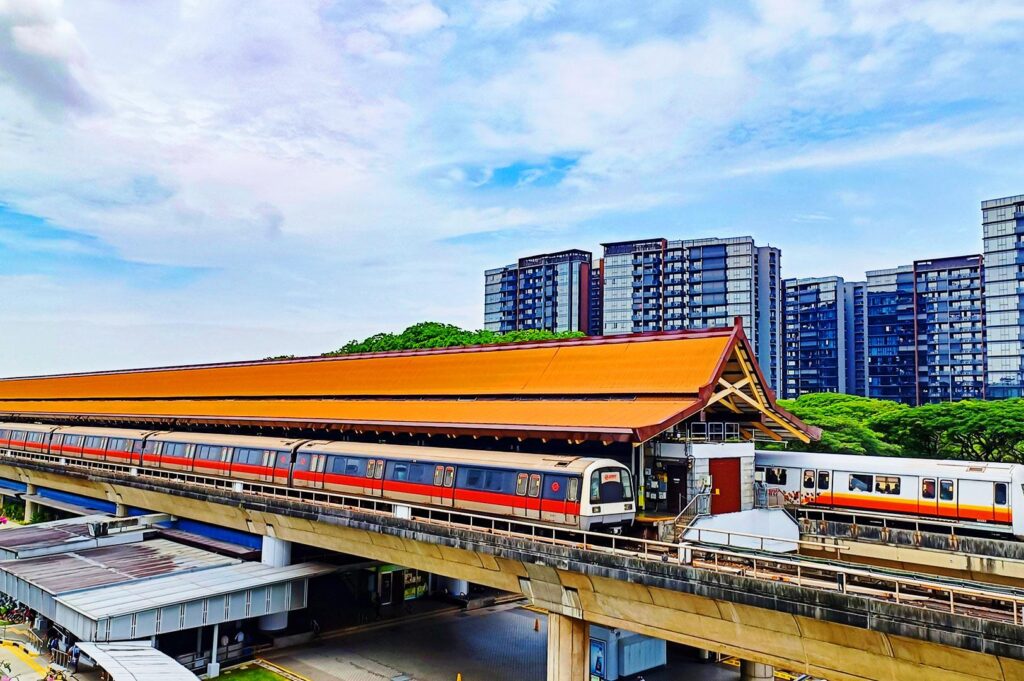 Eunos MRT station Singapore East-West Line with train platform and nearby residential skyline connecting to Katong East Coast area