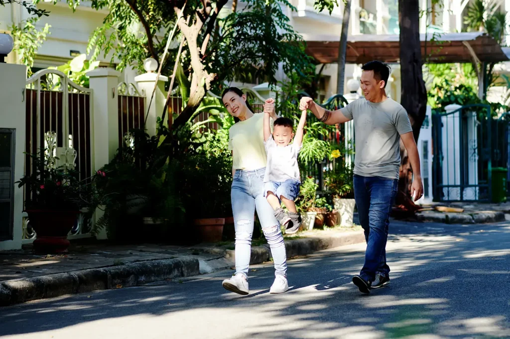 expat family walking in Singapore residential neighborhood near schools family lifestyle and housing choice