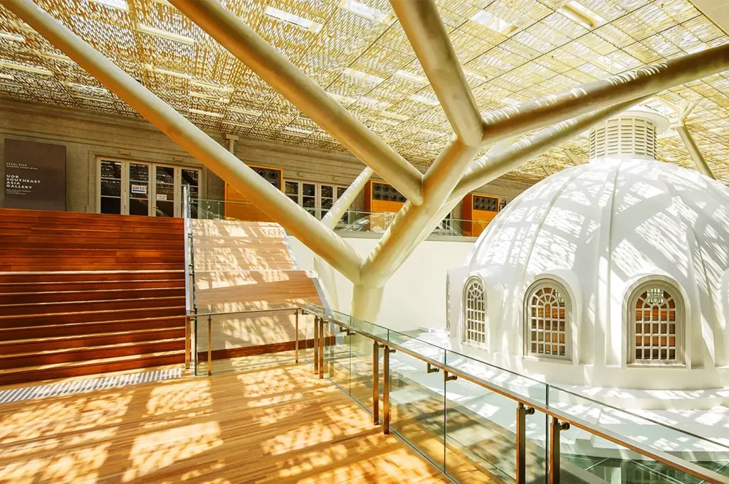 Modern interior architecture inside National Gallery Singapore with natural sunlight and heritage design details