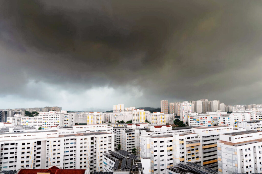 Dark monsoon clouds gathering over Singapore HDB estate before a tropical thunderstorm