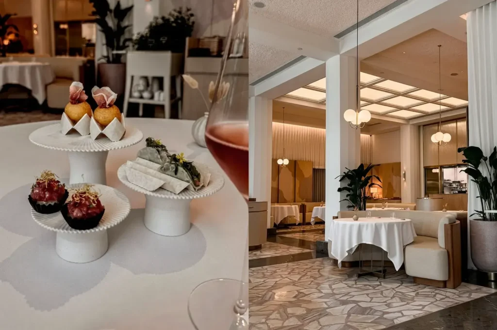 Fine dining desserts on white pedestals and elegant restaurant interior.