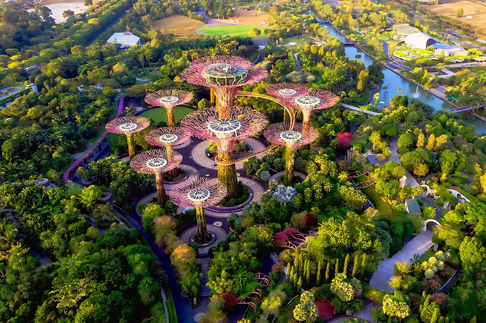 Aerial view of Gardens by the Bay Singapore featuring Supertree Grove surrounded by lush tropical greenery and waterfront landscapes