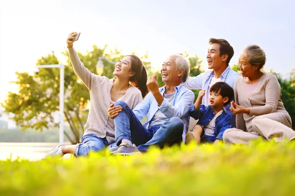 Multi-generational Asian family enjoying outdoor park time in Singapore symbolizing belonging and citizenship journey