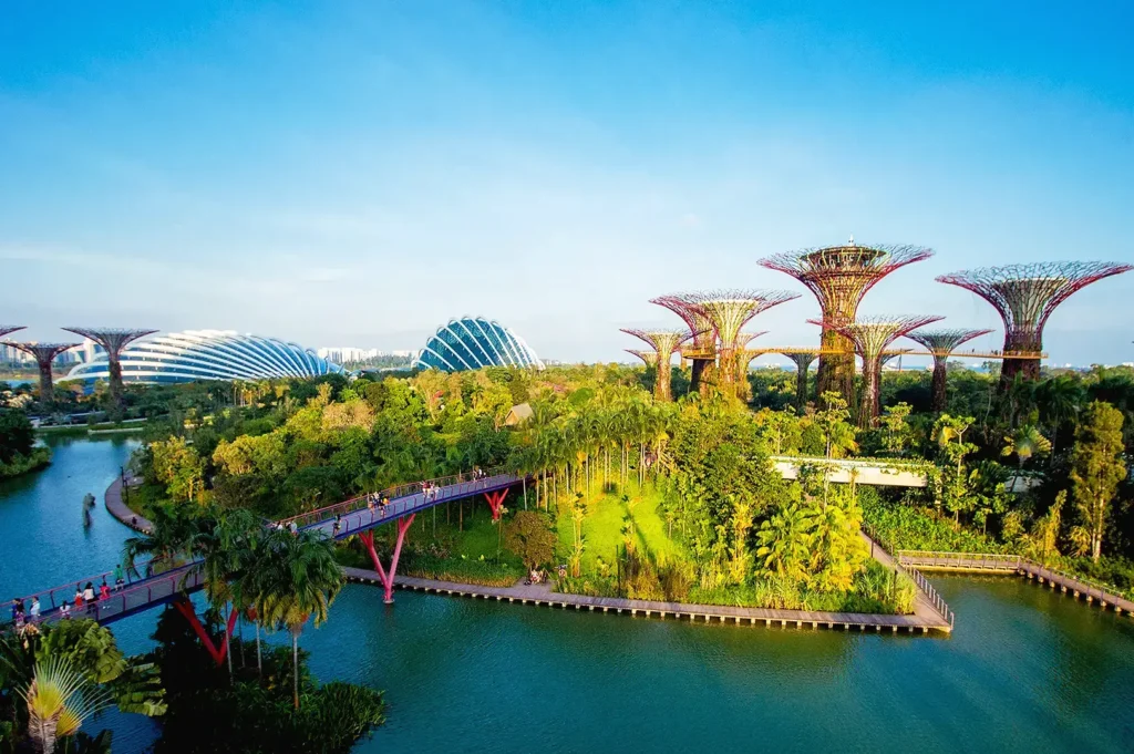 Panoramic view of Gardens by the Bay Singapore with Supertree Grove, waterfront boardwalks, and iconic conservatory domes