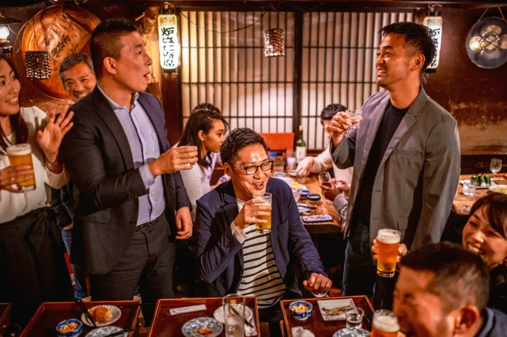 After work drinks and conversation inside lively Japanese izakaya restaurant in Singapore
