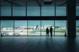 Silhouettes at Changi Airport viewing aircraft.