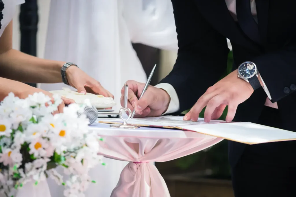 Couple signing wedding registry.